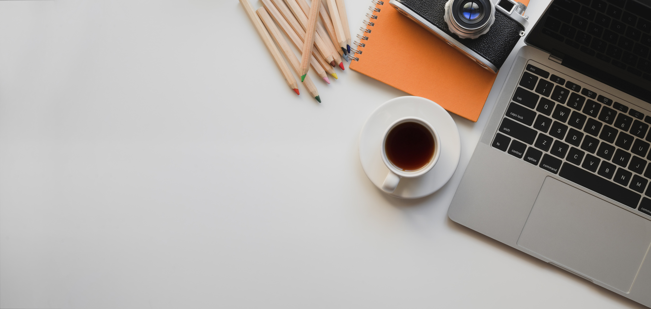 Laptop with coffee cup on creative desk